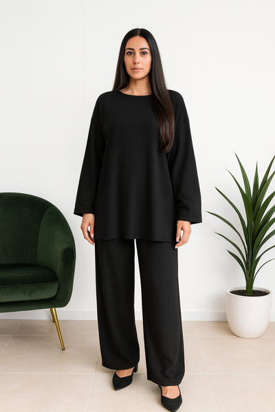 Femme portant un ensemble large en maille côtelée noir, coupe ample et élégante, taille unique 38 à 48.